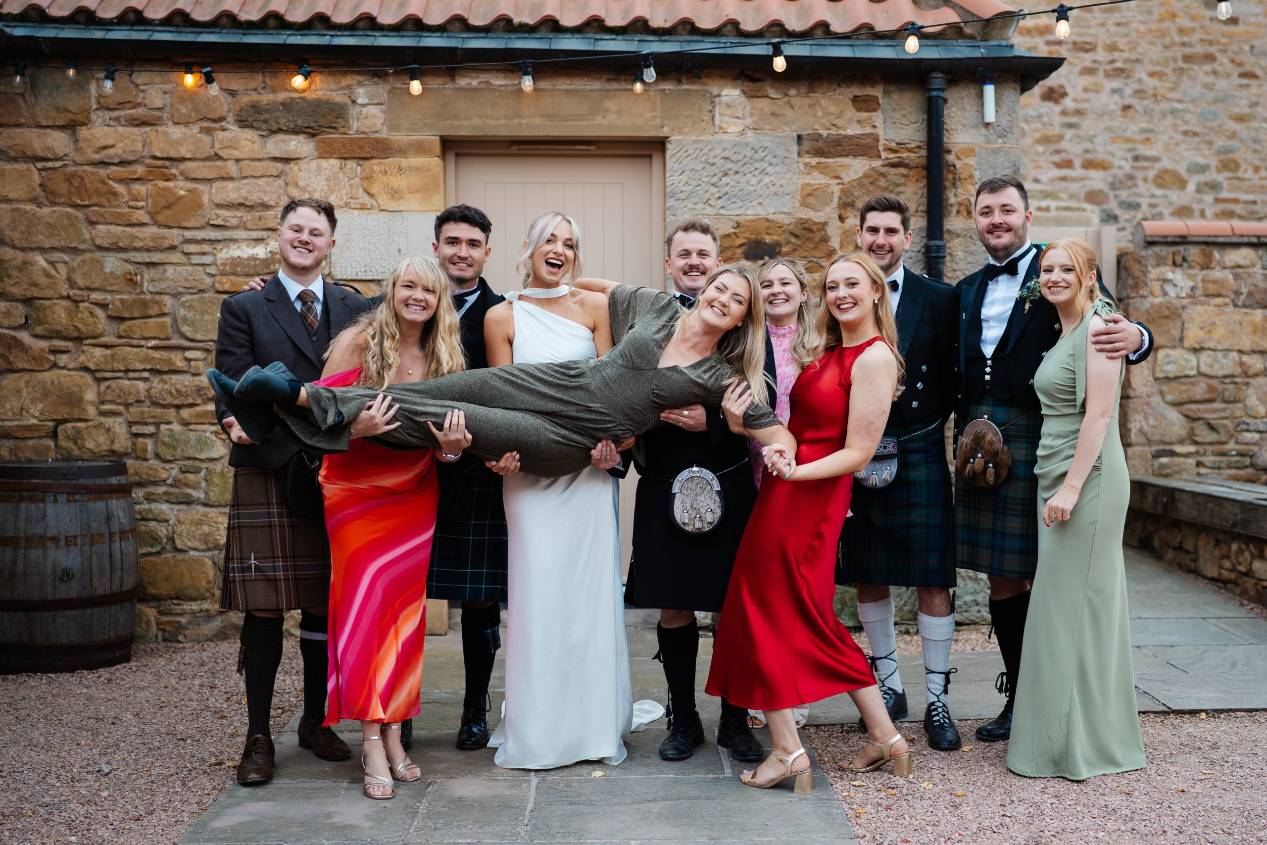 Couples hold up their wedding photographer, Victoria Photography